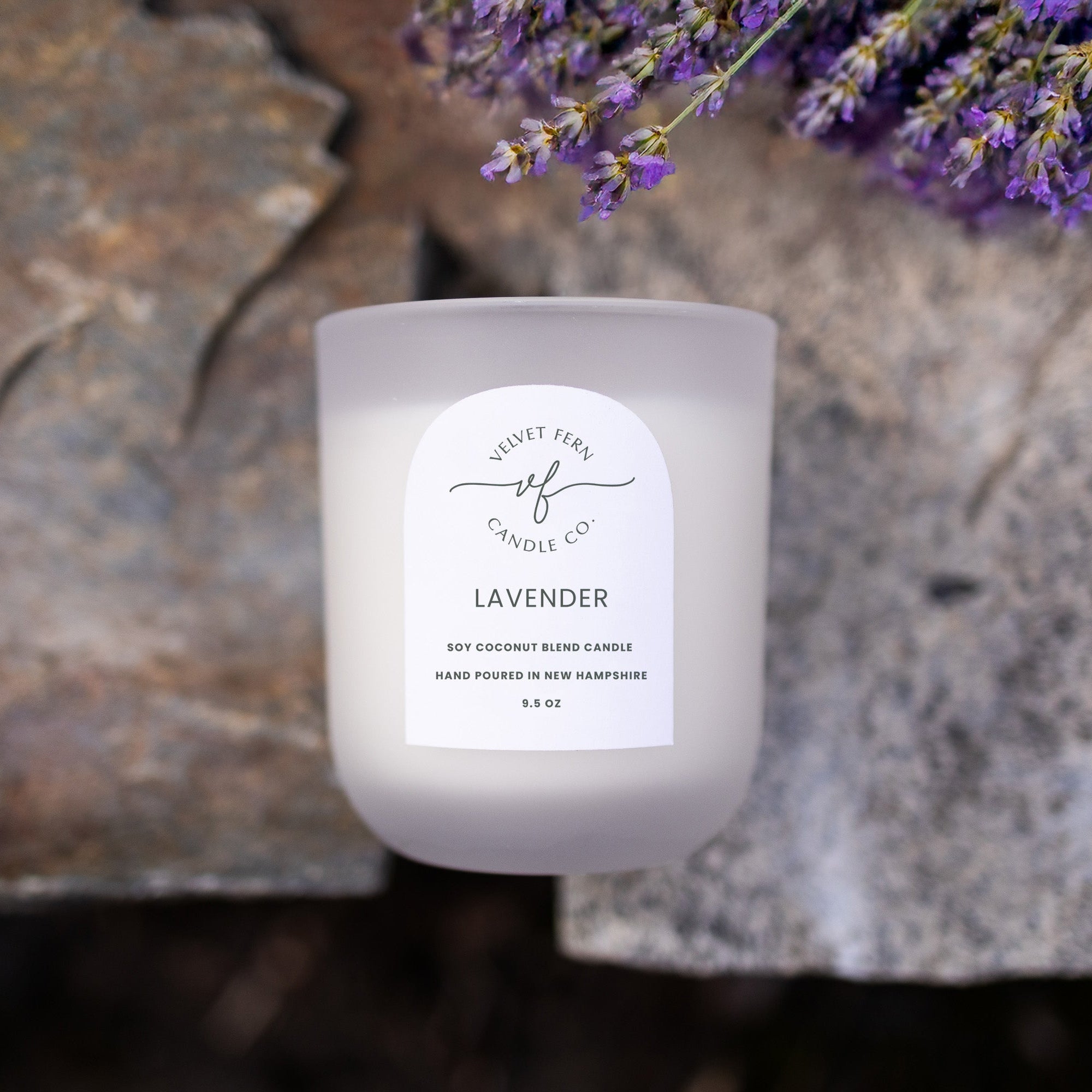 Lavender candle on a stone surface.